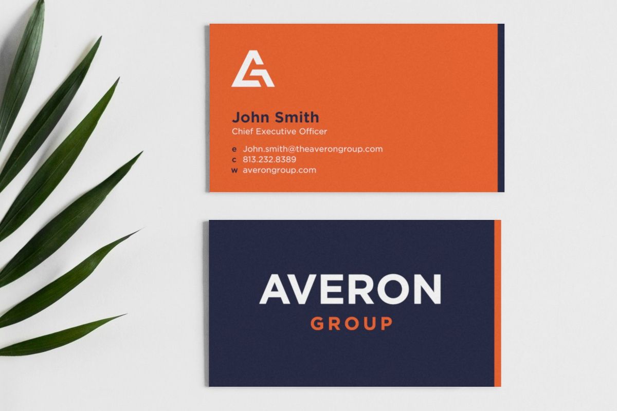 Averon Group business cards beside a palm leaf: an orange front with the AG logo, a name, title and contact details, and a navy back with the Averon Group logo.