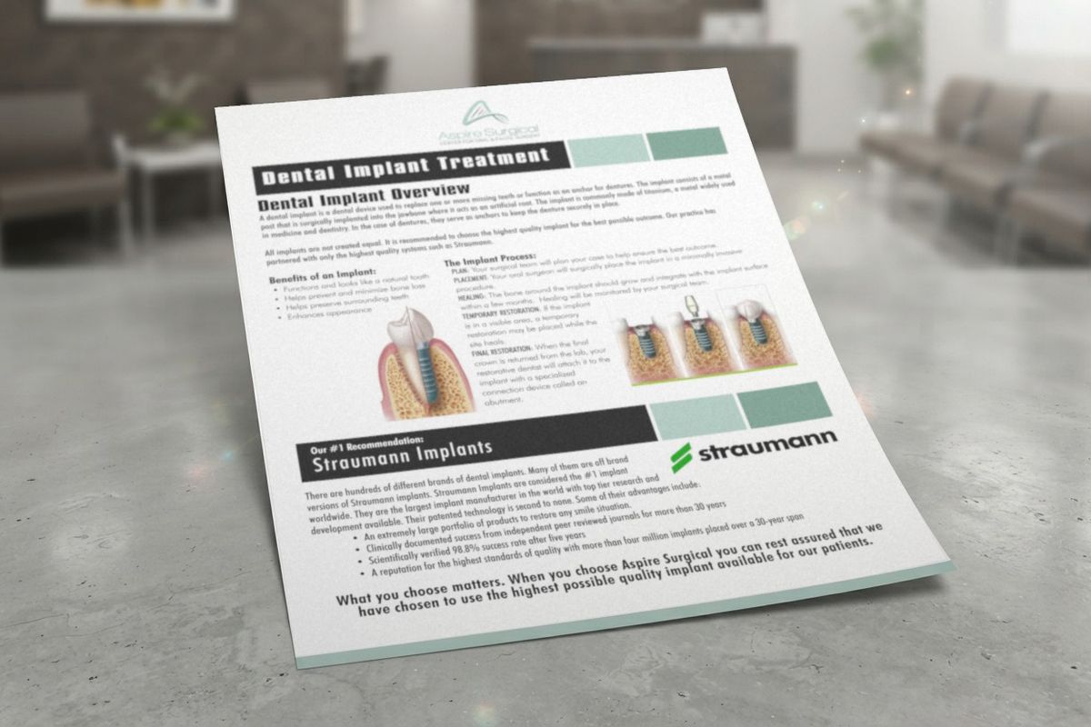 Aspire Surgical flyer titled "Dental Implant Treatment", with implant diagrams and a section recommending Straumann implants, propped on a counter in a waiting room.