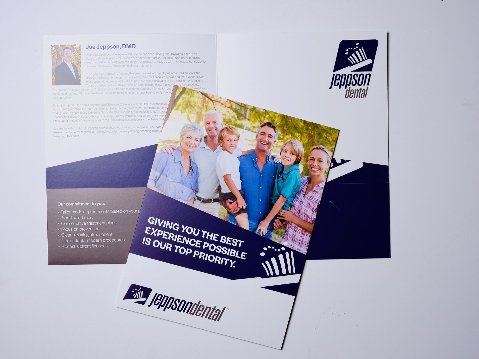 Open Jeppson Dental presentation folder with a family photo insert.